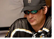 -- Phil Hellmuth with dark sunglasses on, branded hat and jersey - in a deep thinking pose --