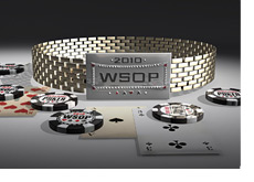 2010 WSOP Bracelet on the table next to cards and chips