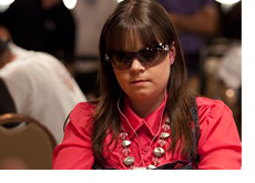 Annette Obrestad with a serious look on her face - Wearing a fancy red shirt and sunglasses