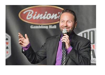 Daniel Negreanu at the podium talking to the public with a big smile on his face.  Binion advertisement in the background