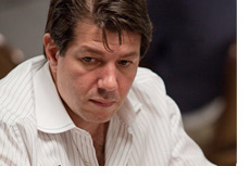 Photo Replacement - David Benyamine at the World Series of Poker 2010 - Wearing a white striped shirt - Looking quite serious