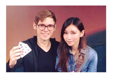 Fedor Holz aka CrownUpGuy wins another tournament. Takes photo next to a pretty girl.