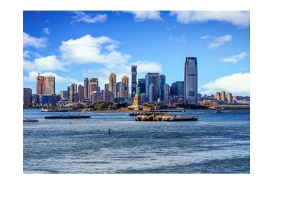 The New Jersey skyline with Statue of Liberty in the foreground.  Very nice photo taken on a very nice day.