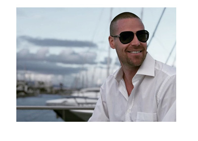 Patrik Antonius looking sharp in a white dress shirt and dark sunglasses - Marina photo - Year is 2018.