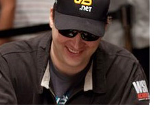 Phill Hellmuth  smiling at the table