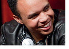 Phil Ivey smiling and looking good in a black jacket