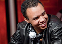 Phil Ivey wearing a leather jacket and a big smile