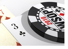 -- World Series of Poker chip on top of playing cards --